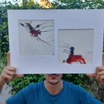 Obra original "Descosido" enmarcada, sostenida por el autor, técnica mixta con tinta roja y azul.